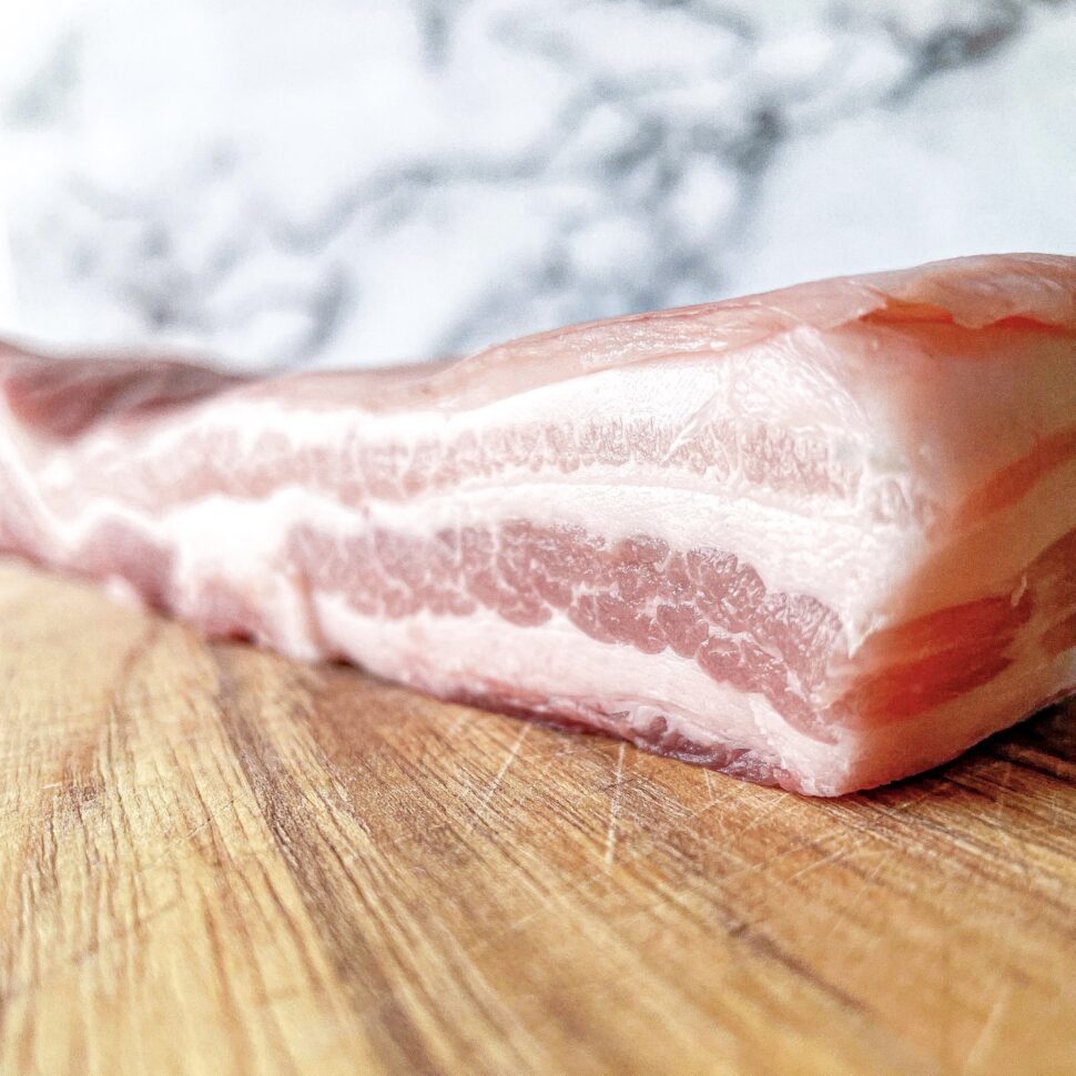 Fresh pork belly being used to make candied pork belly burnt ends.