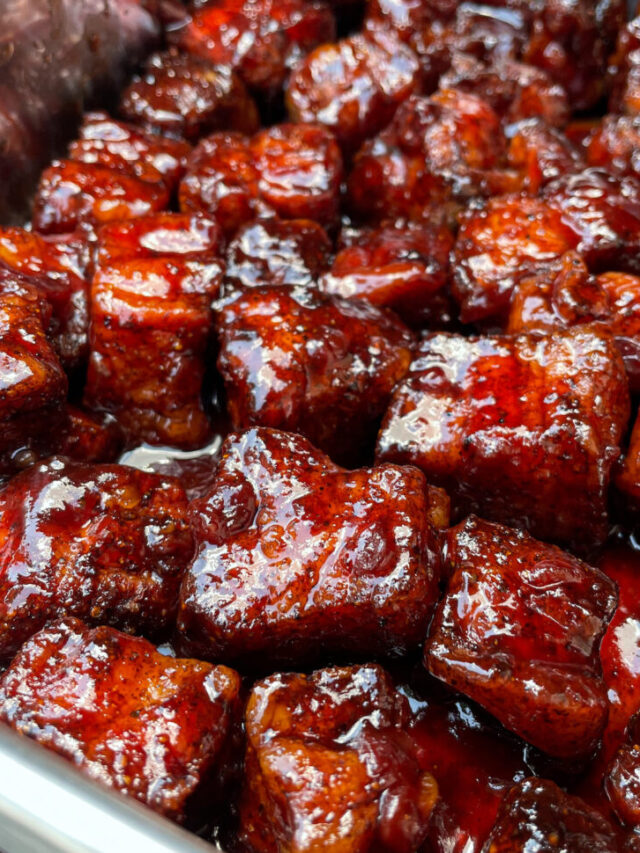 Smoked Pork Belly Burnt ends are tossed in BBQ sauce and returned to the smoker.