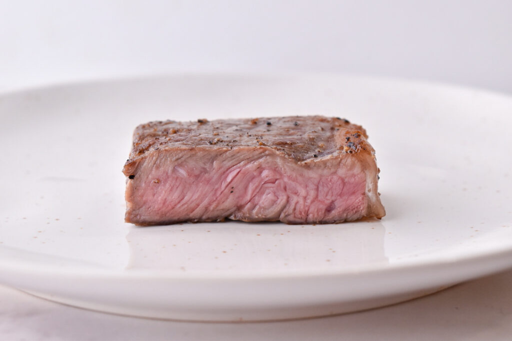 Steak Doneness Levels: Medium-well steak pictured at the perfect temperature doneness
