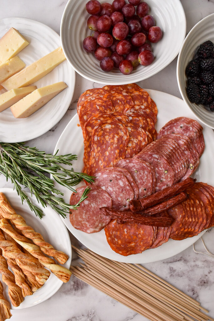 Ingredients and supplies to make Charcuterie Skewers