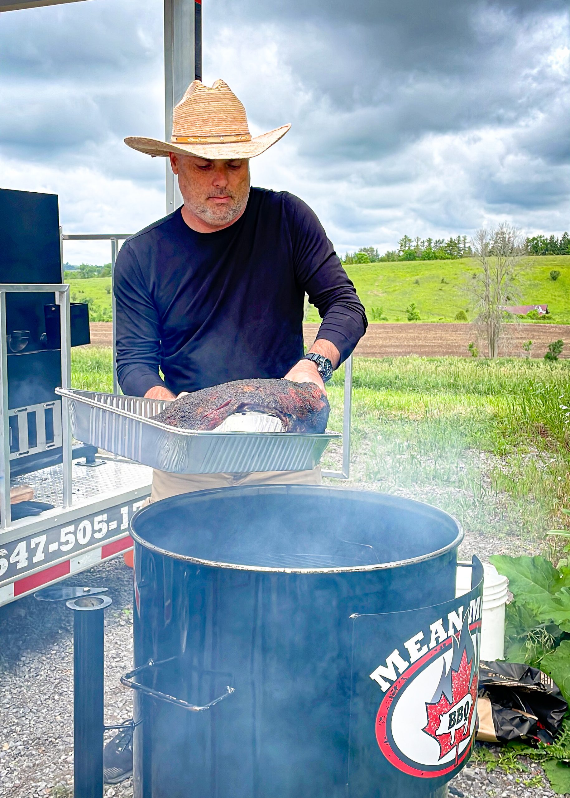 Angus brisket going onto a drum smoker at a BBQ competition in Ontario, Canada.