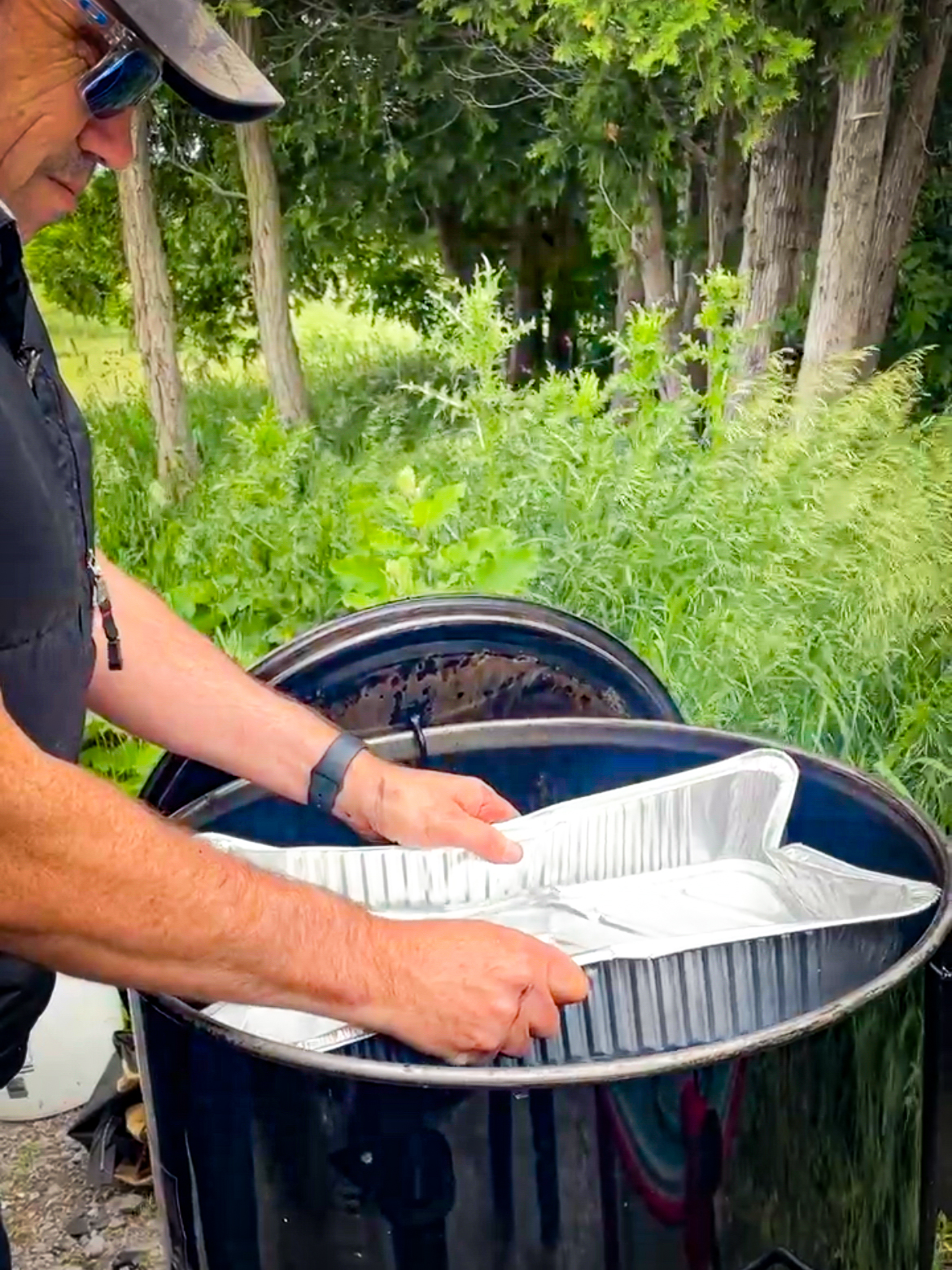 Water pan being added to smoker